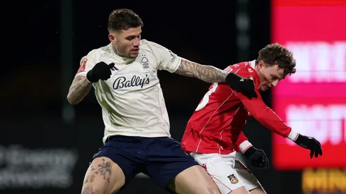 Nathan Broadhead of Wrexham is challenged by Morato of Nottingham Forest.