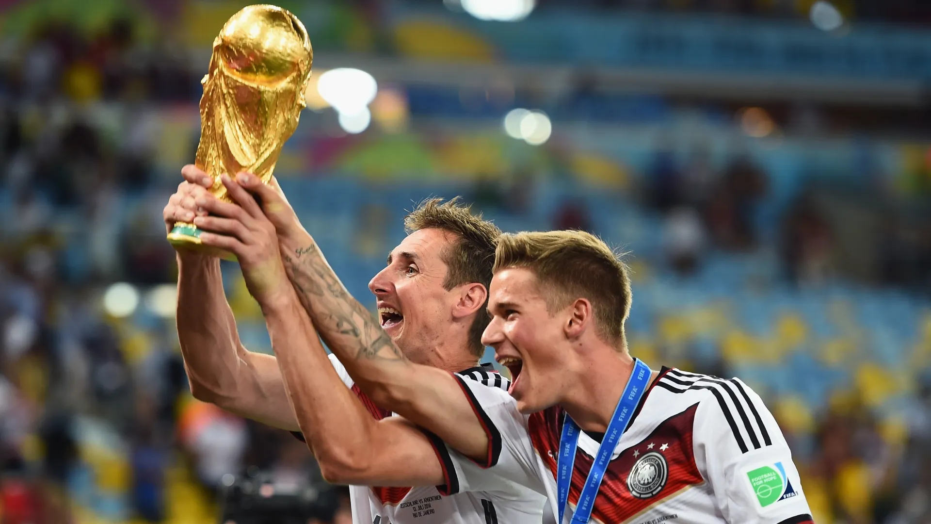 Miroslav Klose and Erik Durm of Germany celebrate with the World Cup trophy.