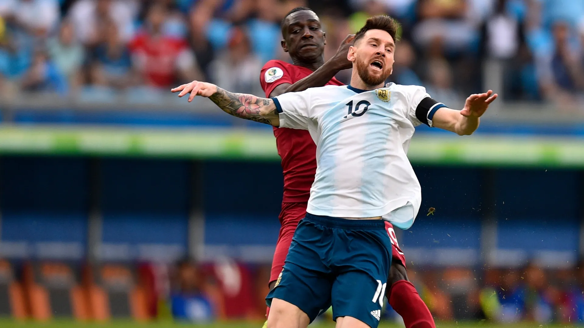 Lionel Messi of Argentina is fouled by Almoez Ali of Qatar during the Copa America Brazil 2019.