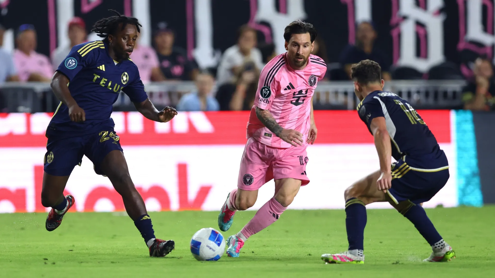 Lionel Messi #10 of Inter Miami CF shoots whilst under pressure from J.C. Ngando #26 of the Vancouver Whitecaps FC during the CONCACAF Champions Cup.