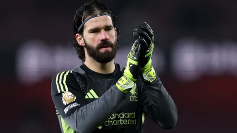 Alisson Becker of Liverpool applauds fans after a Premier League match.