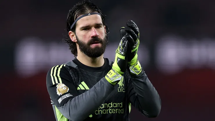 Alisson Becker of Liverpool applauds fans after a Premier League match.