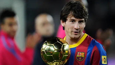 Lionel Messi of FC Barcelona holds the Ballon d'Or trophy