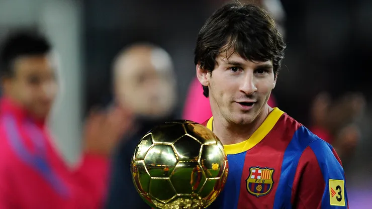 Lionel Messi of FC Barcelona holds the Ballon d'Or trophy