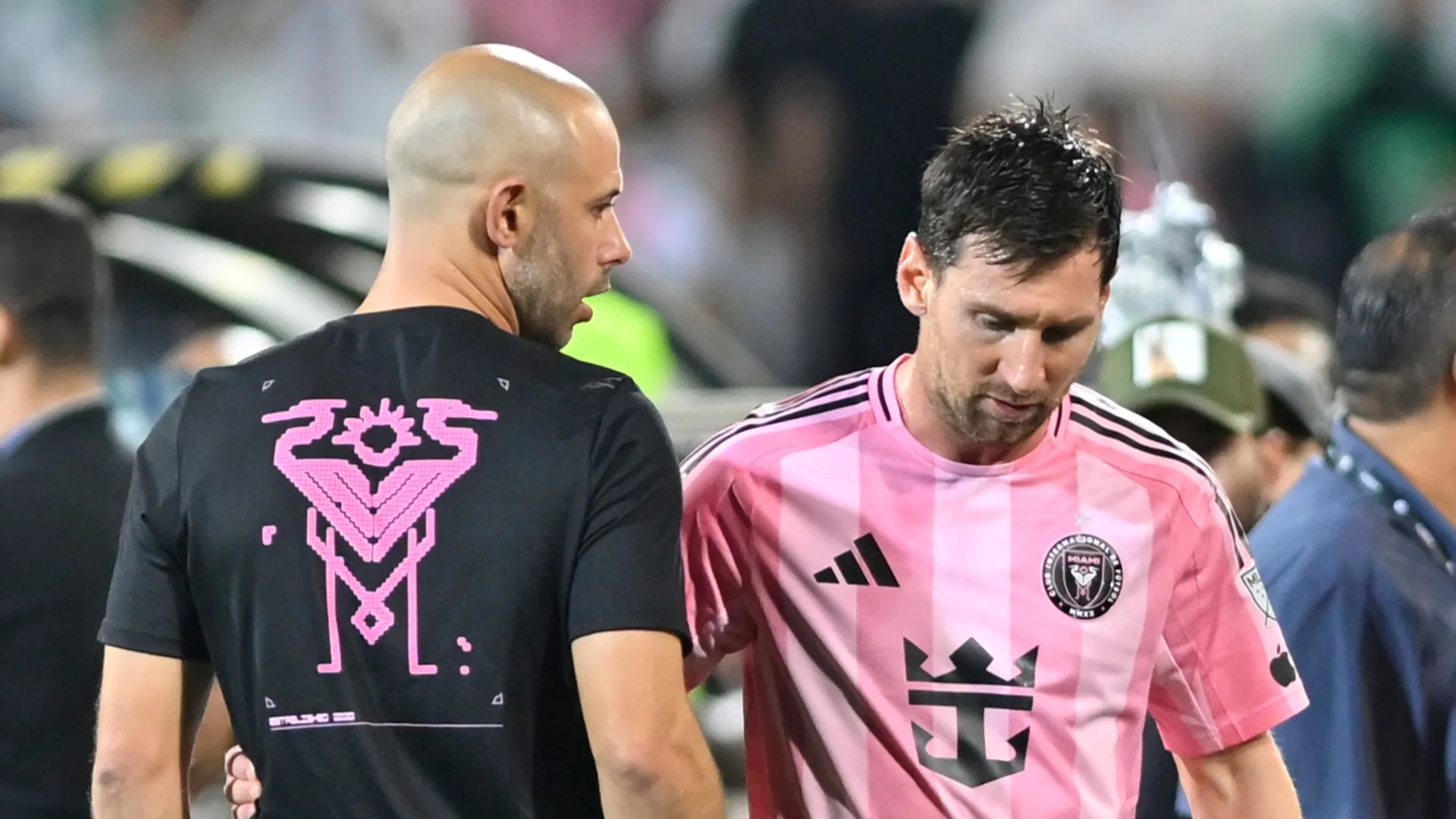 Lionel Messi of Inter Miami talks with Javier Mascherano as he leaves the field.