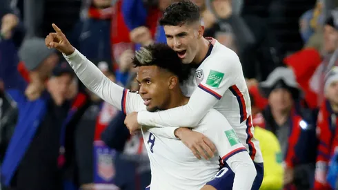 Weston McKennie #8 of the United States is congratulated by Christian Pulisic #10 after scoring a goal.