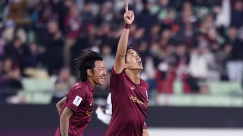 Yoshinori Muto of Vissel Kobe celebrates with teammate Yosuke Ideguchi after scoring a goal.