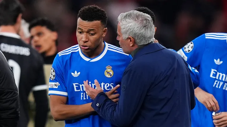 Kylian Mbappe of Real Madrid speaks to Jose Mourinho, Head Coach of Benfica.