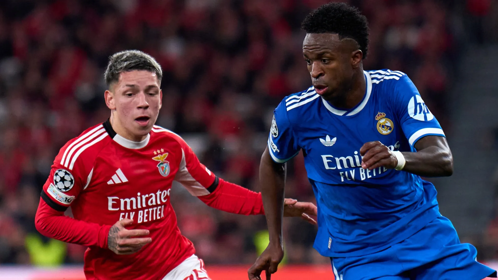 Vinicius Junior of Real Madrid is challenged by Gianluca Prestianni of SL Benfica.