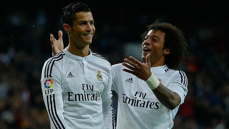 Cristiano Ronaldo (L) of Real Madrid CF celebrates scoring with teammate Marcelo (R)