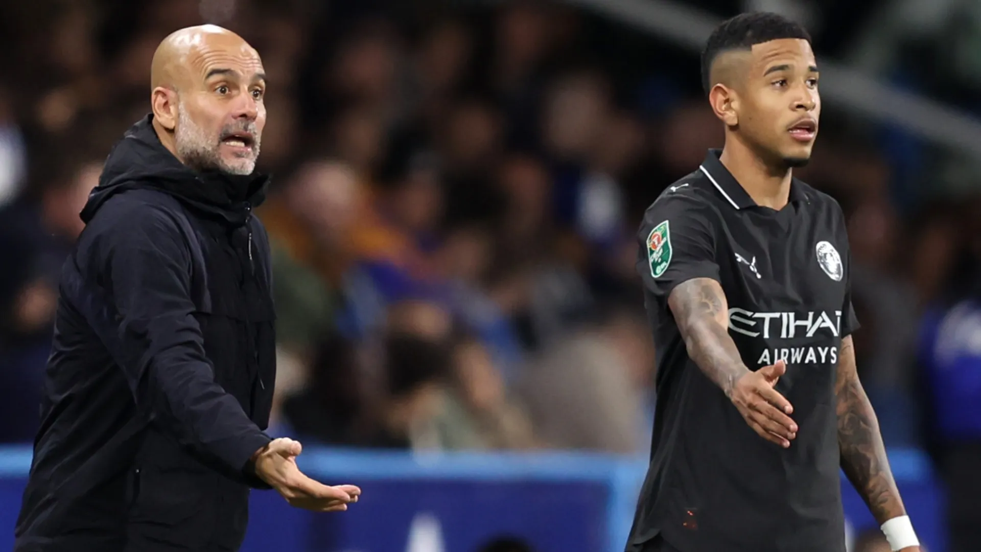 Pep Guardiola, Manager of Manchester City, reacts alongside Savinho.