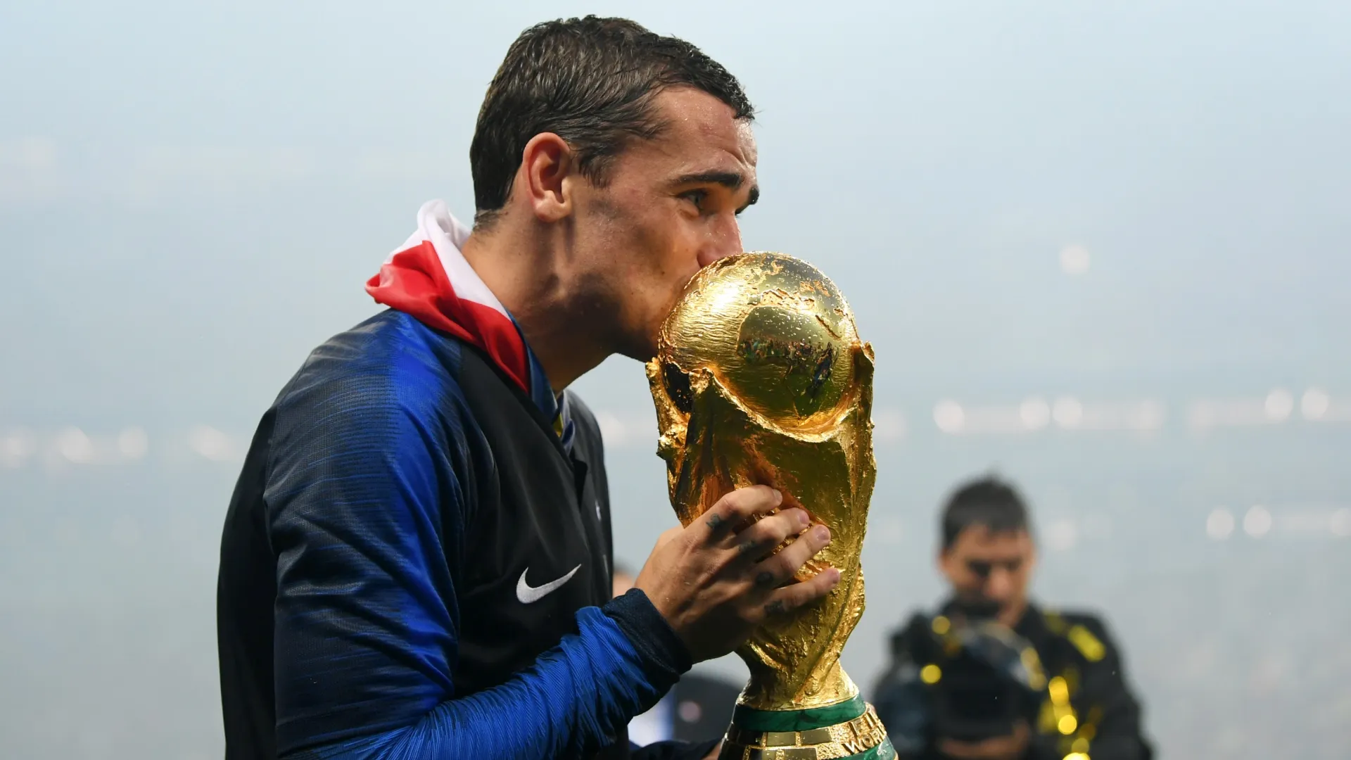 Antoine Griezmann of France kisses the World Cup trophy.