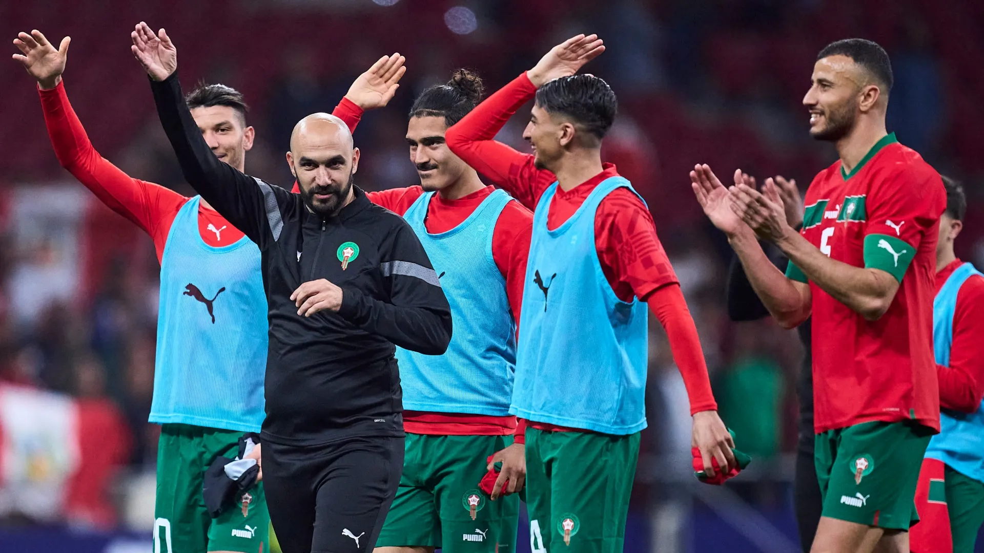Morocco's Walid Regragui and players waving fans