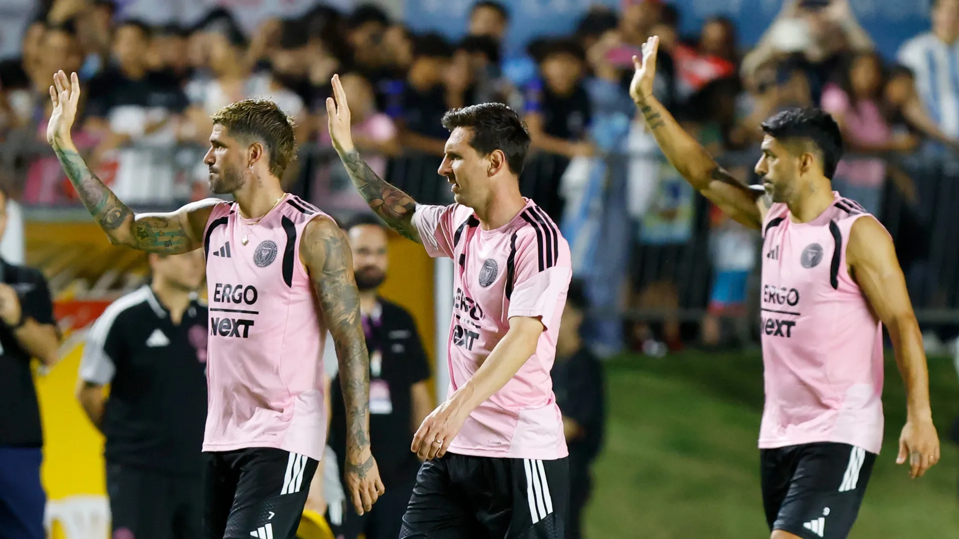 Rodrigo de Paul (L), Lionel Messi (C) and Luis Suarez (R) of Inter Miami wave during a training session at Estadio Juan Ramón Loubriel.