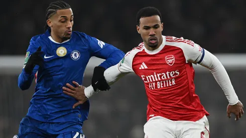 Gabriel Magalhaes of Arsenal is challenged by Joao Pedro of Chelsea.