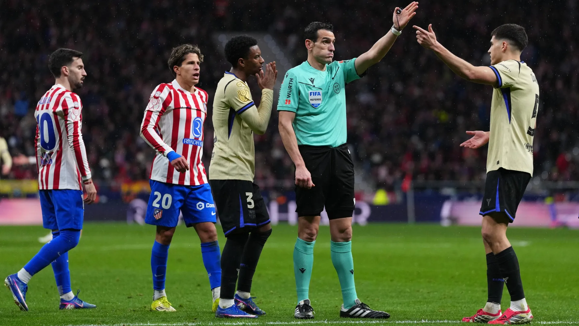 Referee Juan Martinez Munuera gestures for a direct free kick after a handball from Eric Garcia of FC Barcelona.