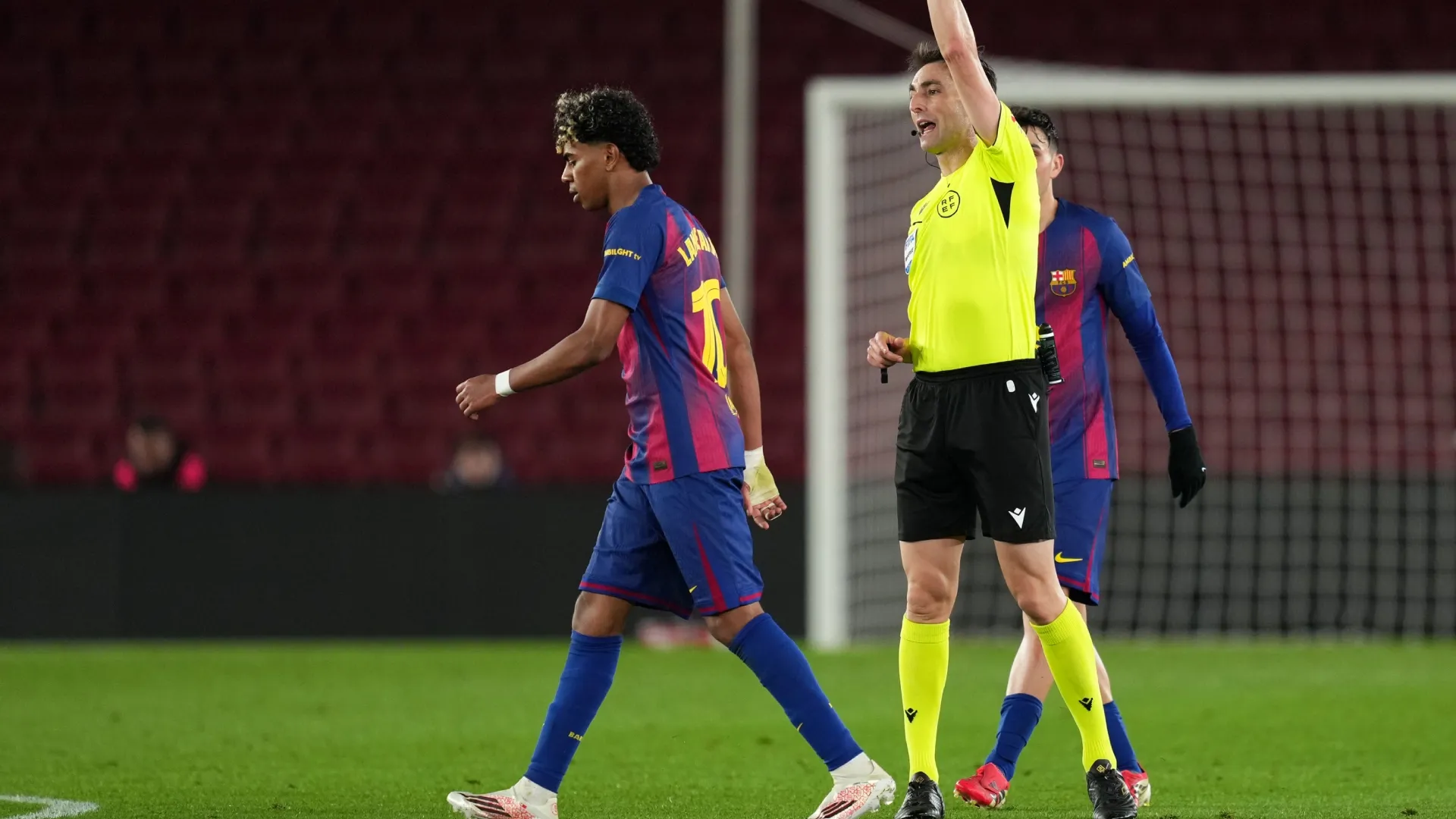 Lamine Yamal of FC Barcelona is shown a yellow card by referee Ricardo De Burgos Bengoetxea.