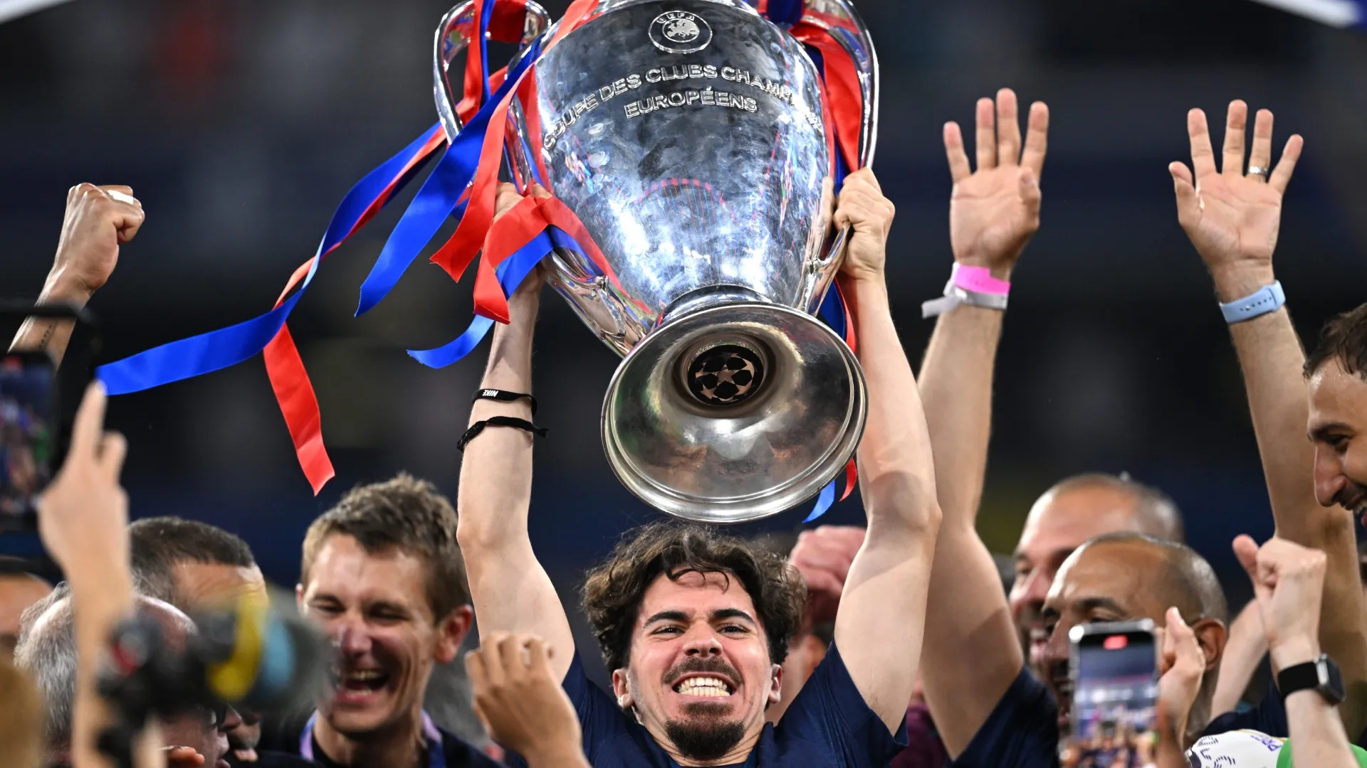 Vitinha of Paris Saint-Germain lifts the UEFA Champions League.