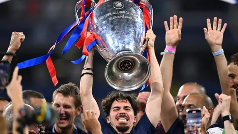 Vitinha of Paris Saint-Germain lifts the UEFA Champions League.