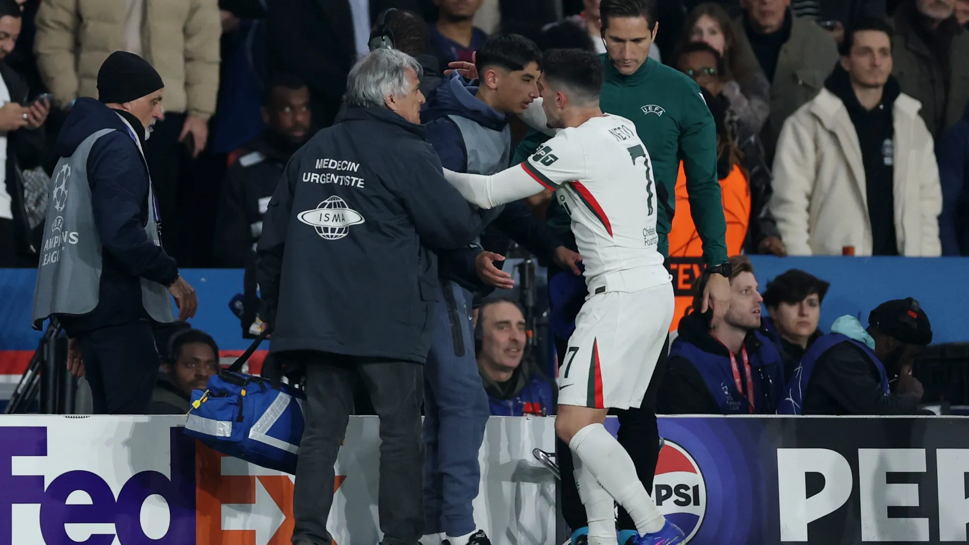 Pedro Neto of Chelsea embraces a ball kid following the altercation.