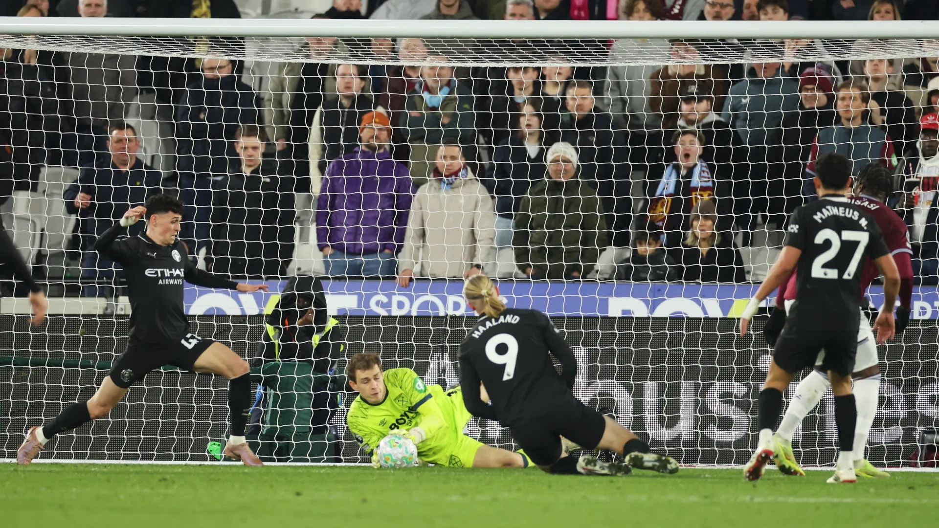 Mads Hermansen of West Ham United saves a shot from Erling Haaland of Manchester City.