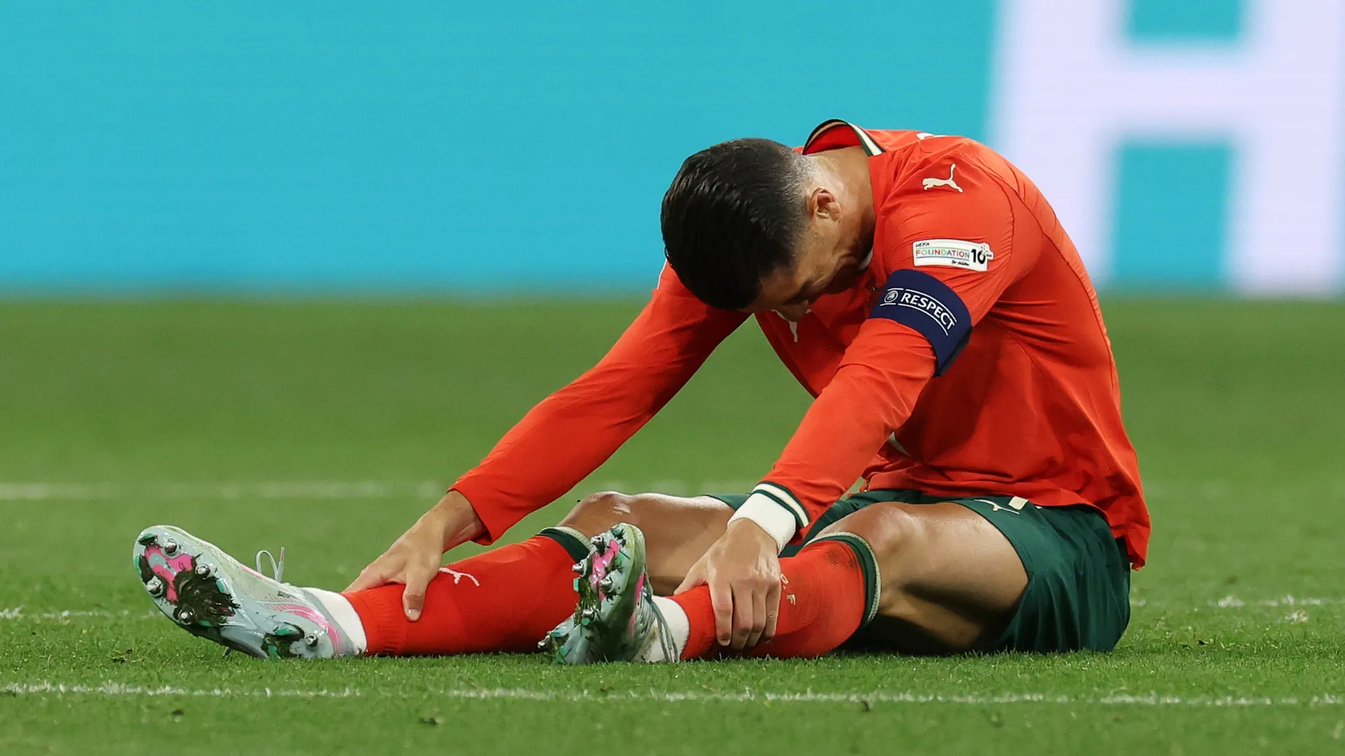 Cristiano Ronaldo of Portugal drops to the floor injured.