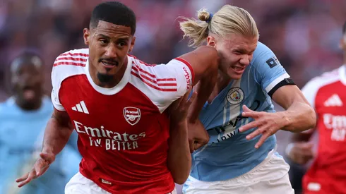 William Saliba of Arsenal battles for possession with Erling Haaland of Manchester City.