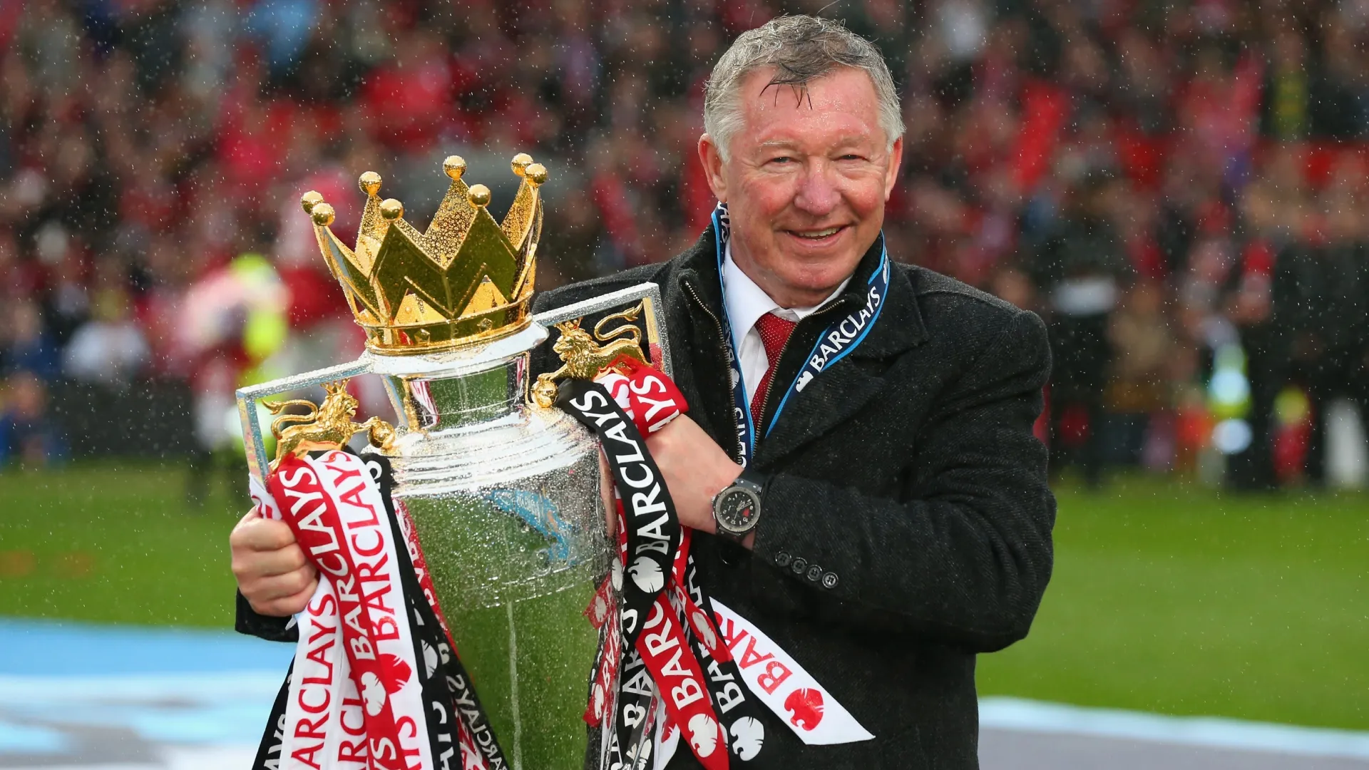Manchester United Manager Sir Alex Ferguson celebrates with the Premier League trophy.