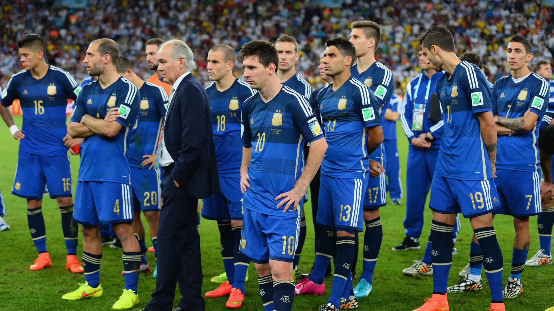 Head coach Alejandro Sabella and Lionel Messi of Argentina looks on with his team after being defeated by Germany 1-0.