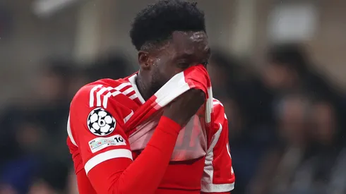 Alphonso Davies of FC Bayern Munich reacts after sustaining an injury during the UEFA Champions League.