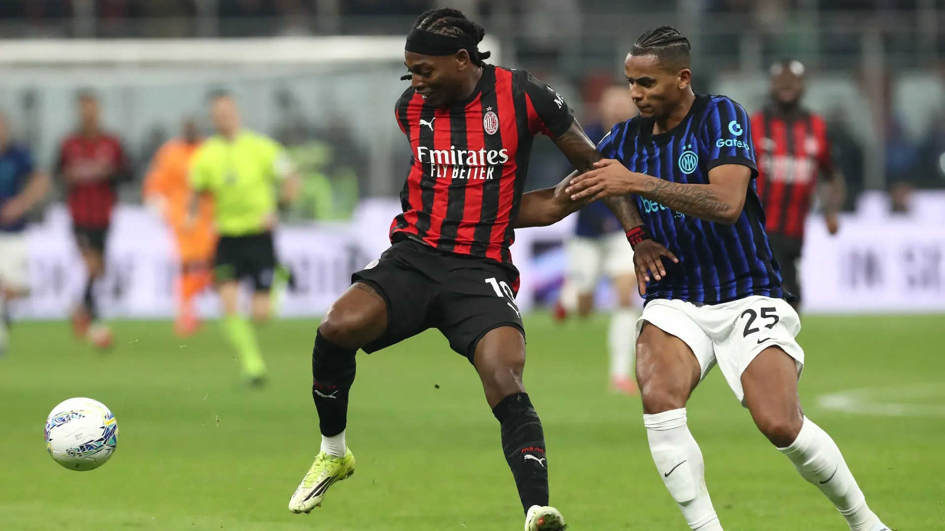 Rafael Leao of AC Milan competes for the ball with Manuel Akanji of FC Inter.