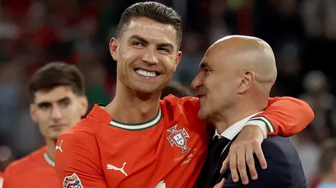 Cristiano Ronaldo of Portugal hugs head coach Roberto Martinez