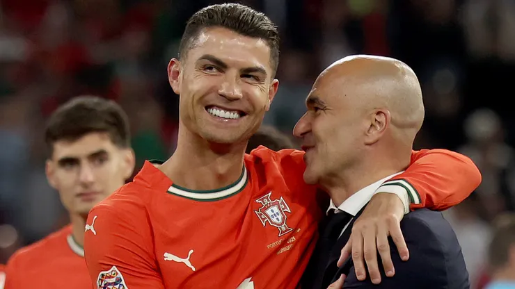Cristiano Ronaldo of Portugal hugs head coach Roberto Martinez