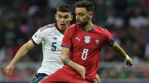 Bruno Fernandes of Portugal is challenged by Johan Vásquez of Mexico.