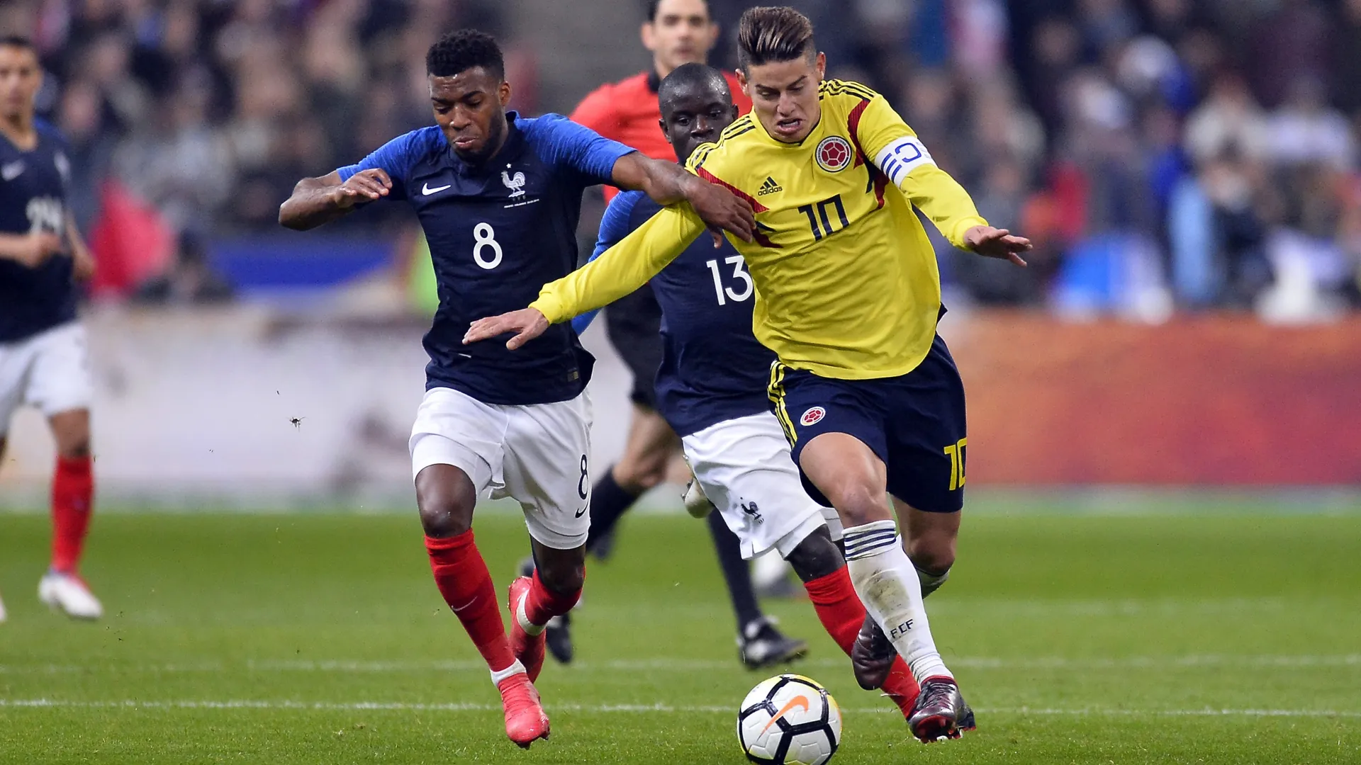 James Rodriguez of Colombia and Thomas Lemar and N Golo Kante of France during a friendly in 2018.