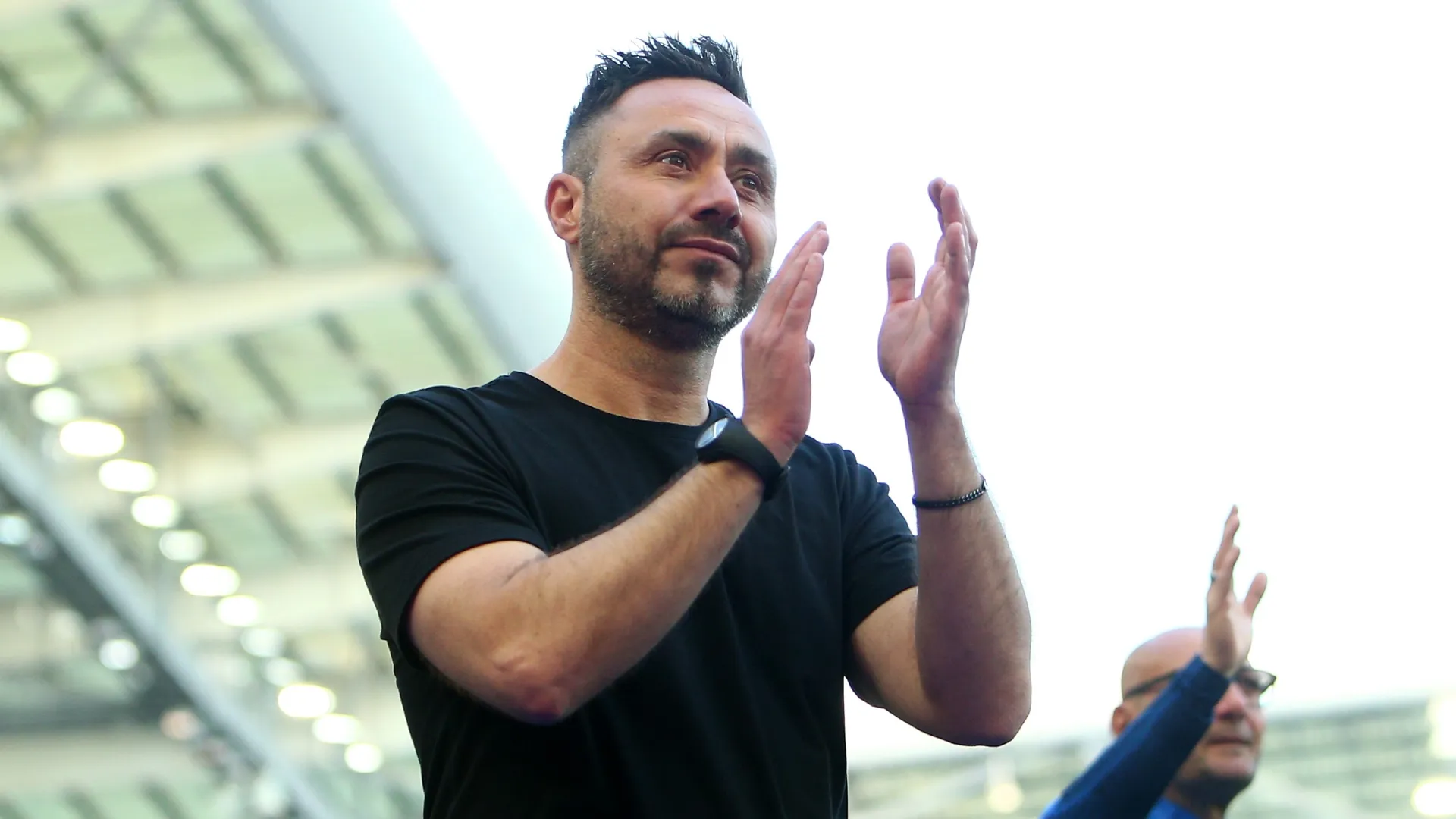 Roberto De Zerbi acknowledges the fans following the Premier League match.