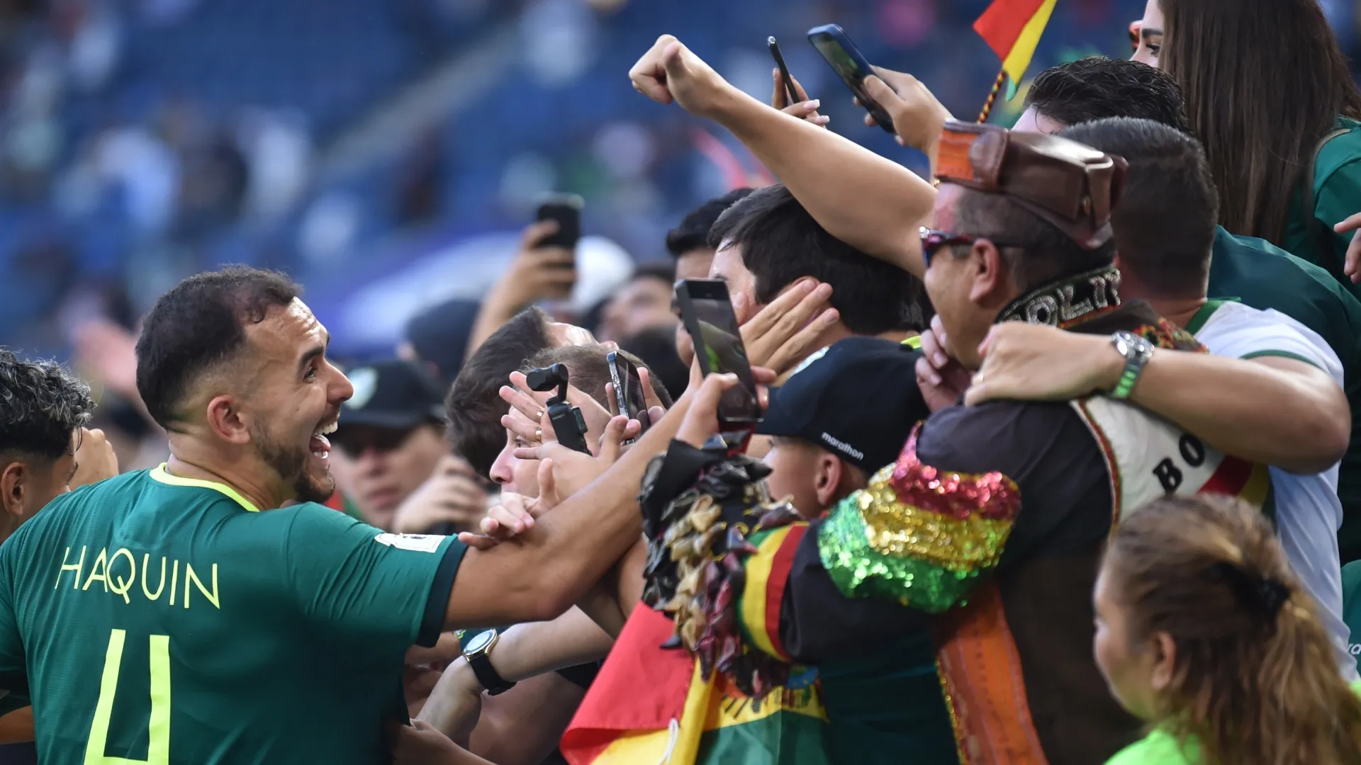 Luis Haquin of Bolivia celebrates with fans after winning against Suriname.