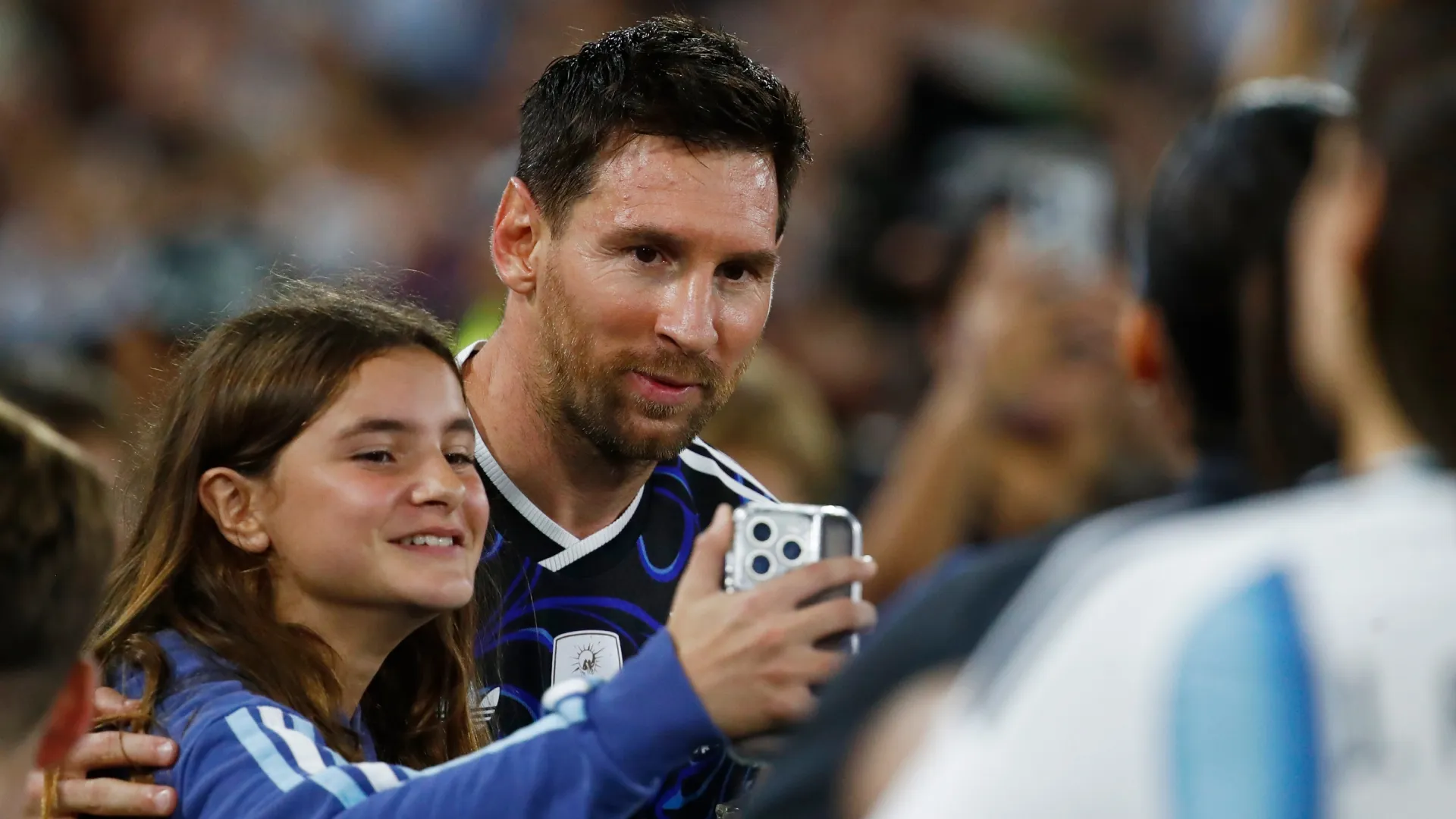 A fan takes a selfie with Lionel Messi of Argentina.