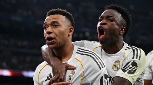 Kylian Mbappe celebrates with Vinicius Junior after scoring a goal.