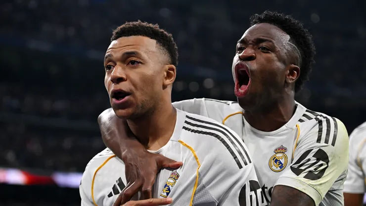 Kylian Mbappe celebrates with Vinicius Junior after scoring a goal.
