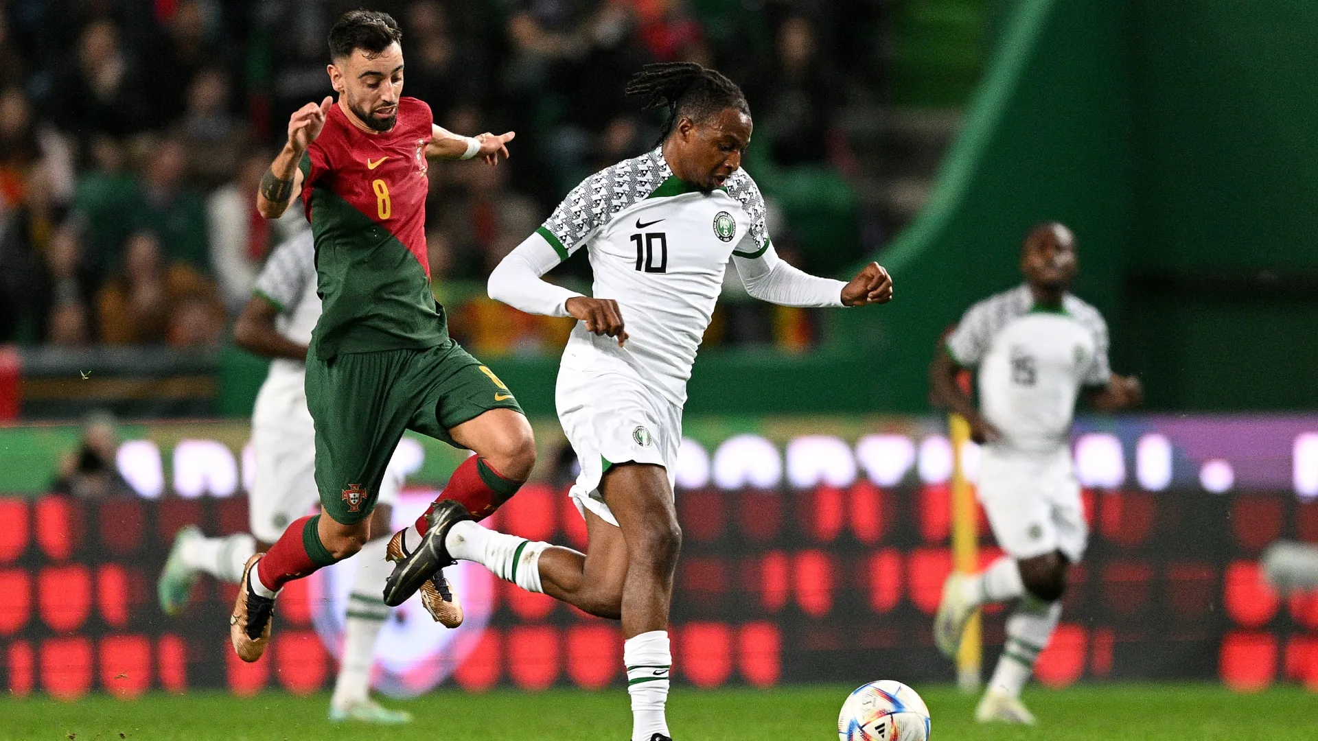 Bruno Fernandes of Portugal challenges Maduks Okoye of Nigeria.
