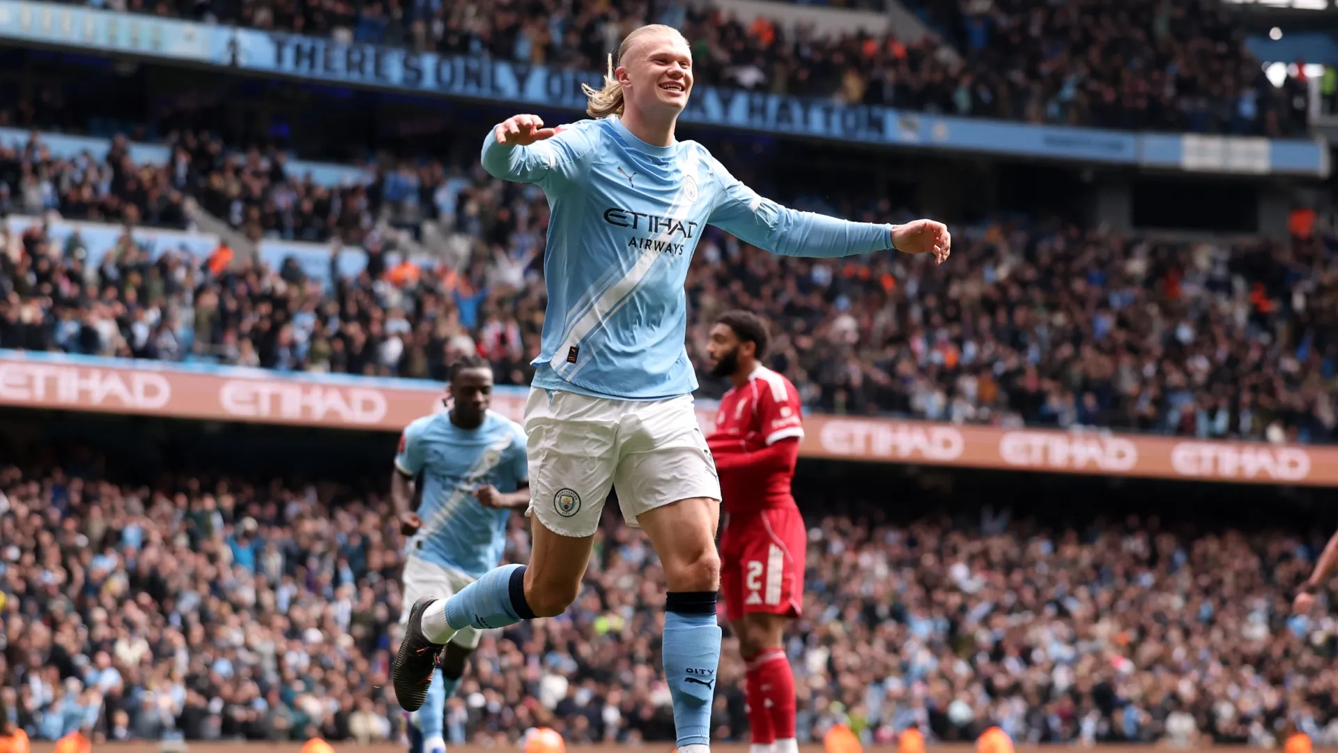 Erling Haaland celebrates after scoring his third goal for Manchester City against Liverpool.