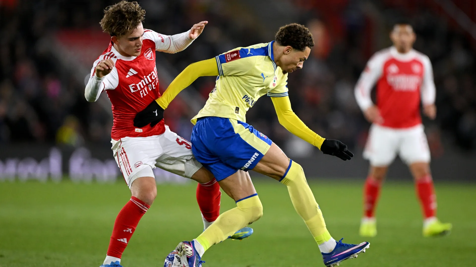 Samuel Edozie of Southampton is tackled by Max Dowman of Arsenal.
