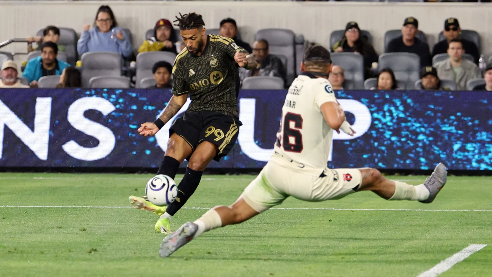 Denis Bouanga #99 of Los Angeles Football Club shoots and scores against Liga Deportiva Alajuelense.