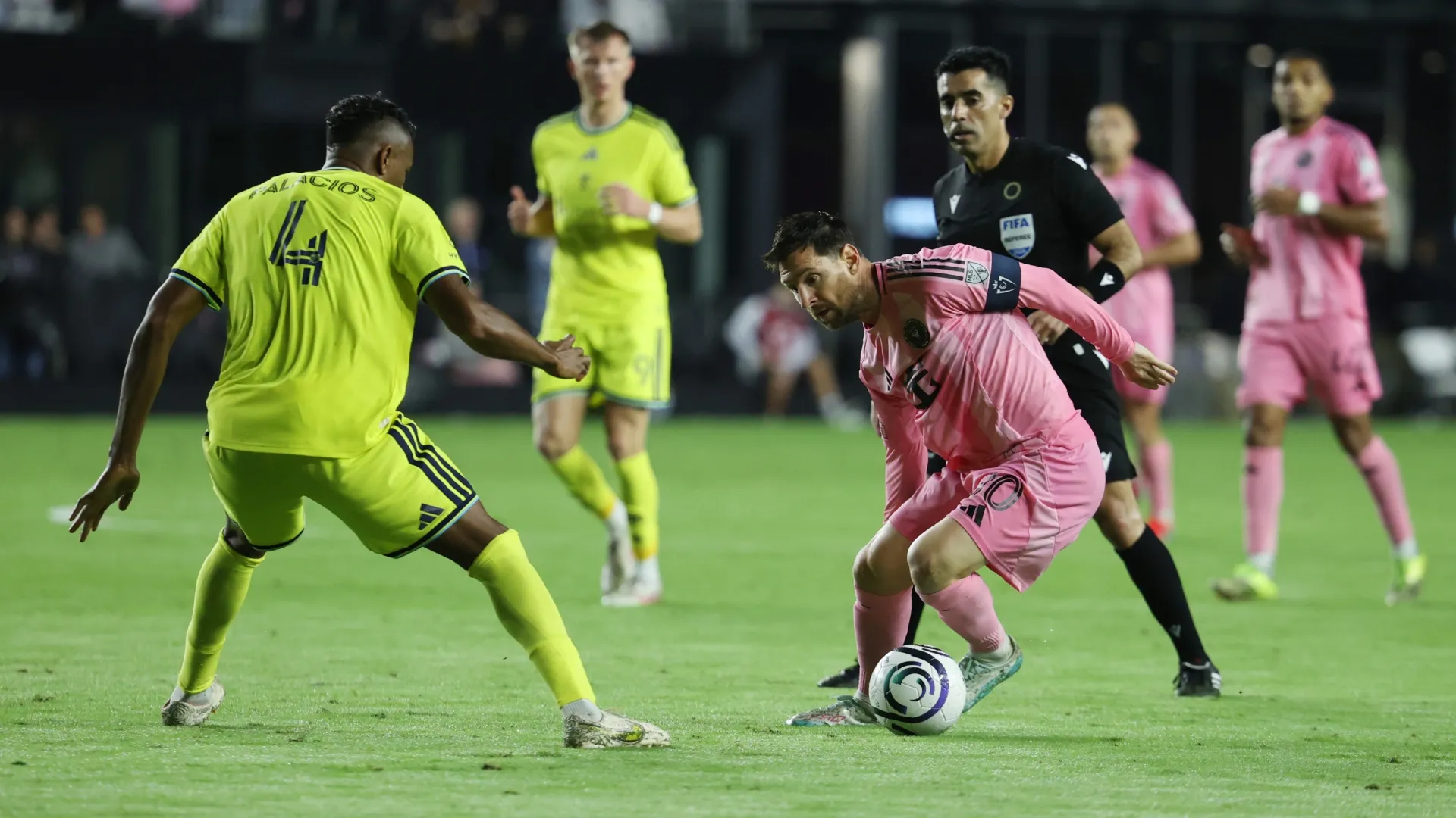 Lionel Messi #10 of Inter Miami CF dribbles the ball against Jeisson Palacios #4 of Nashville SC.