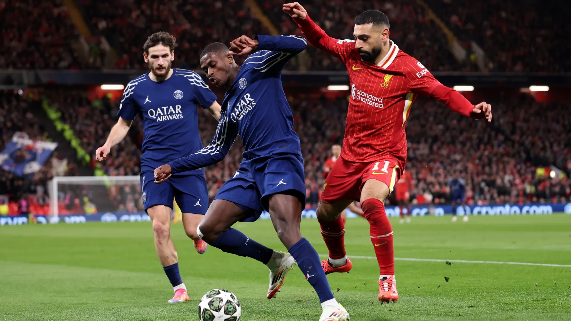 PSG star Nuno Mendes controls the ball under pressure from Liverpool star Mohamed Salah