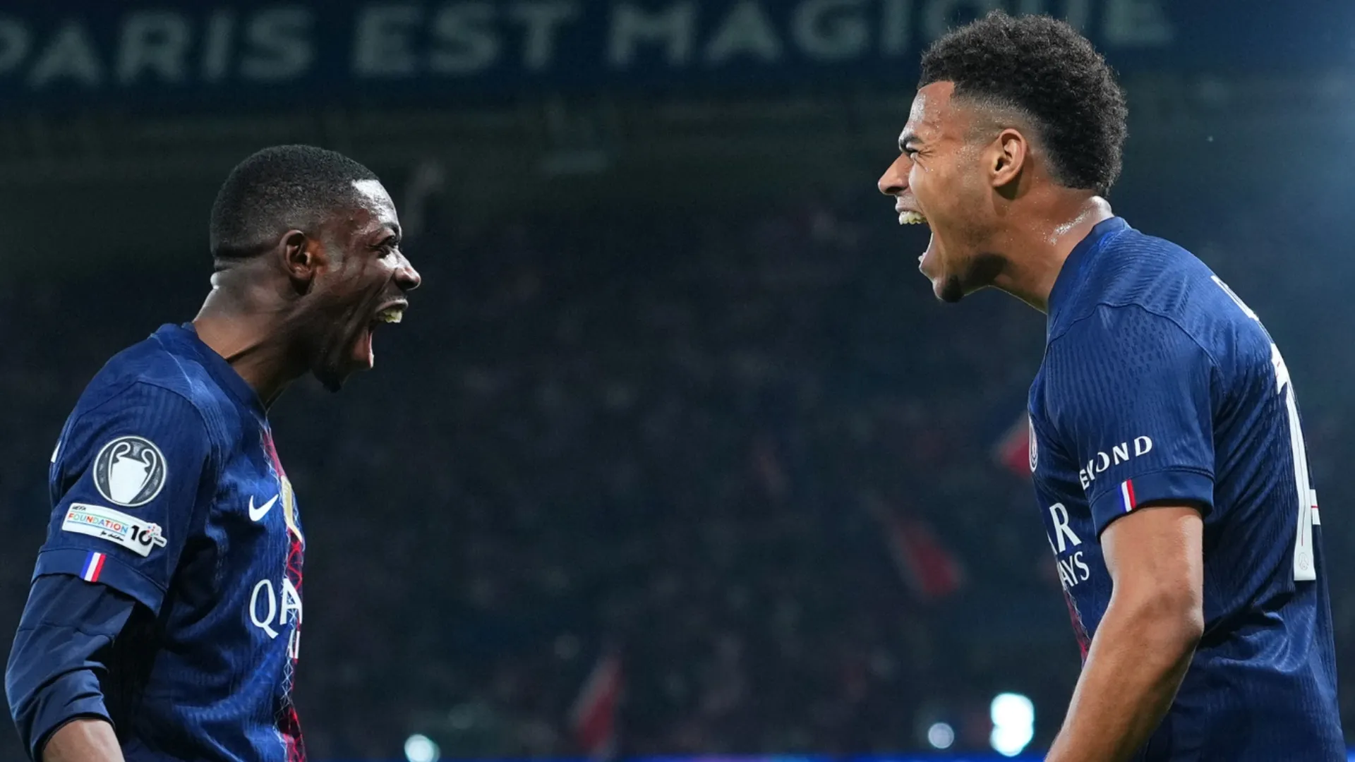 Desire Doue of Paris Saint-Germain celebrates scoring a goal with Ousmane Dembele.