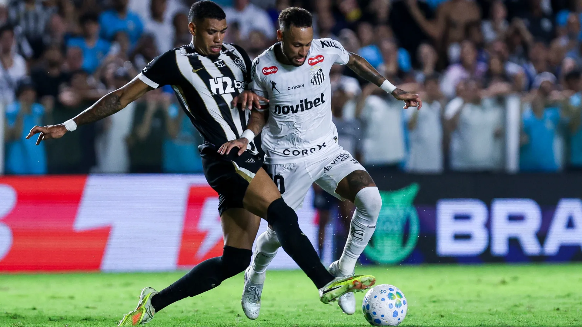 Neymar Junior of Santos competes for the ball with Ruan of Atletico Mineiro.