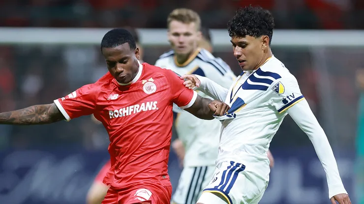 Helinho of Toluca competes for the ball against Edwin Cerrillo of LA Galaxy