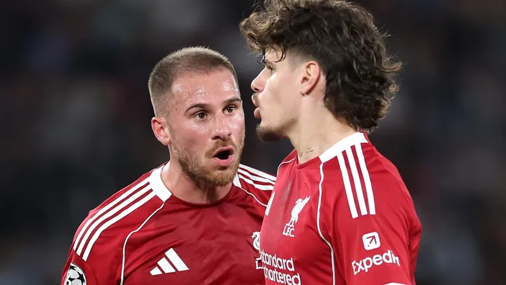 Alexis Mac Allister of Liverpool speaks with teammate Milos Kerkez.